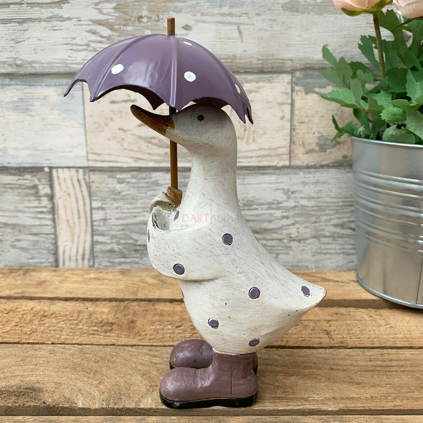 Lila gepunktete Ente mit Regenschirm