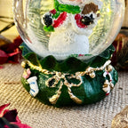 Snowman In Green Sack Snow Globe
