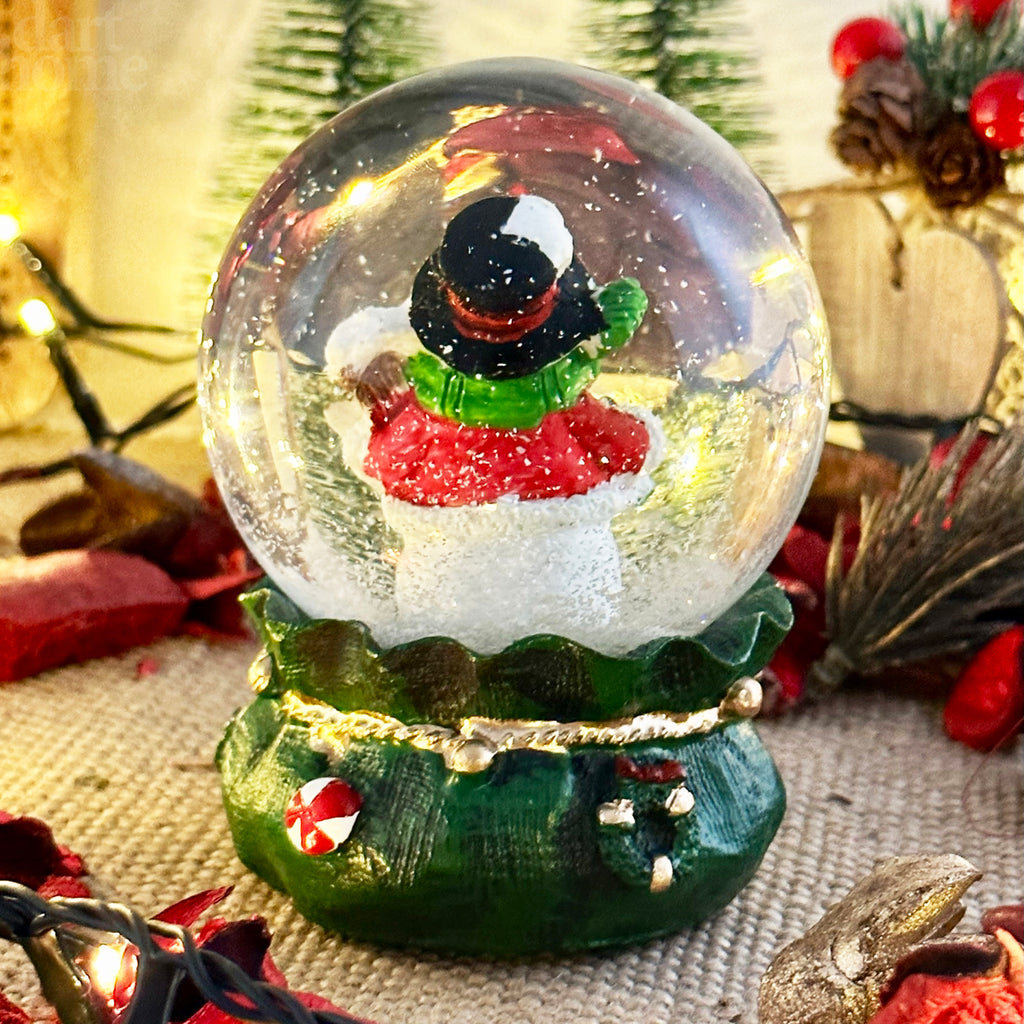 Snowman In Green Sack Snow Globe