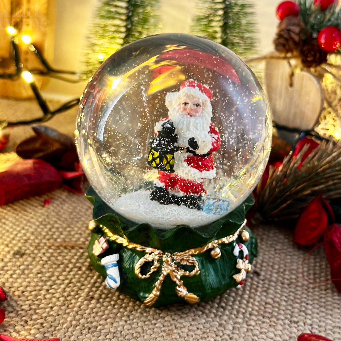 Santa Claus In Green Sack Snow Globe