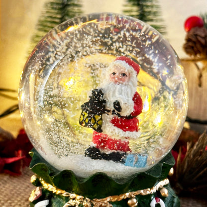 Santa Claus In Green Sack Snow Globe