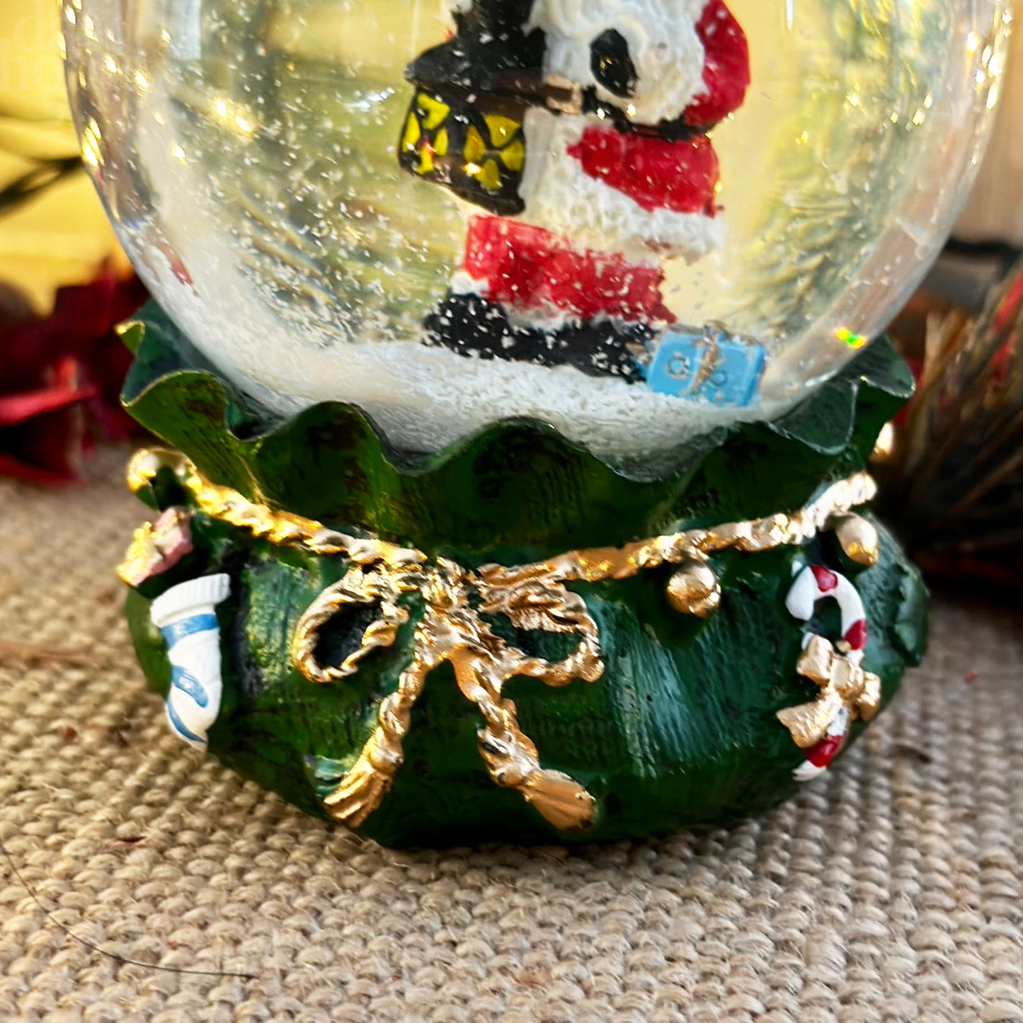 Santa Claus In Green Sack Snow Globe