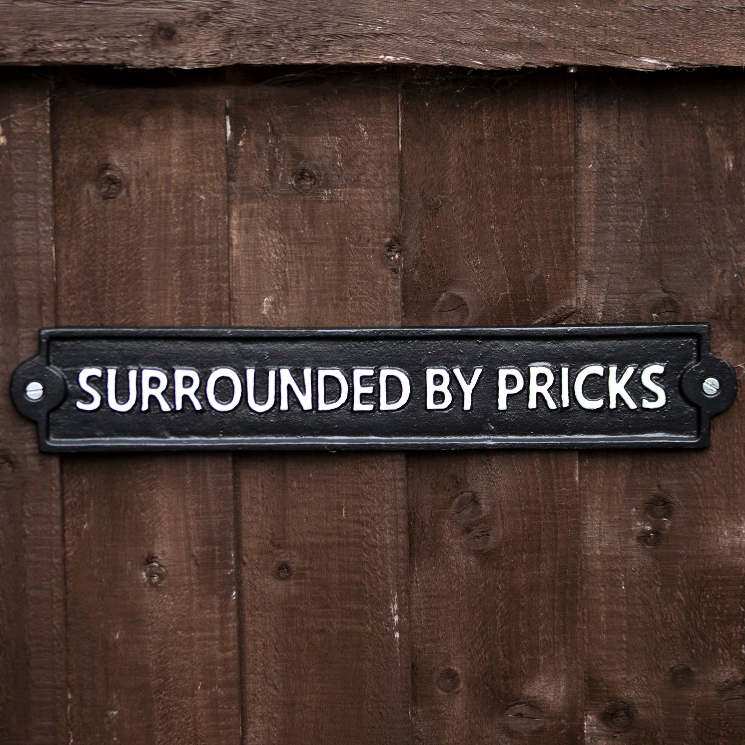 Surrounded By Pr*cks Sign