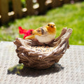 Decorative bird feeder with a robin perched on a nest background