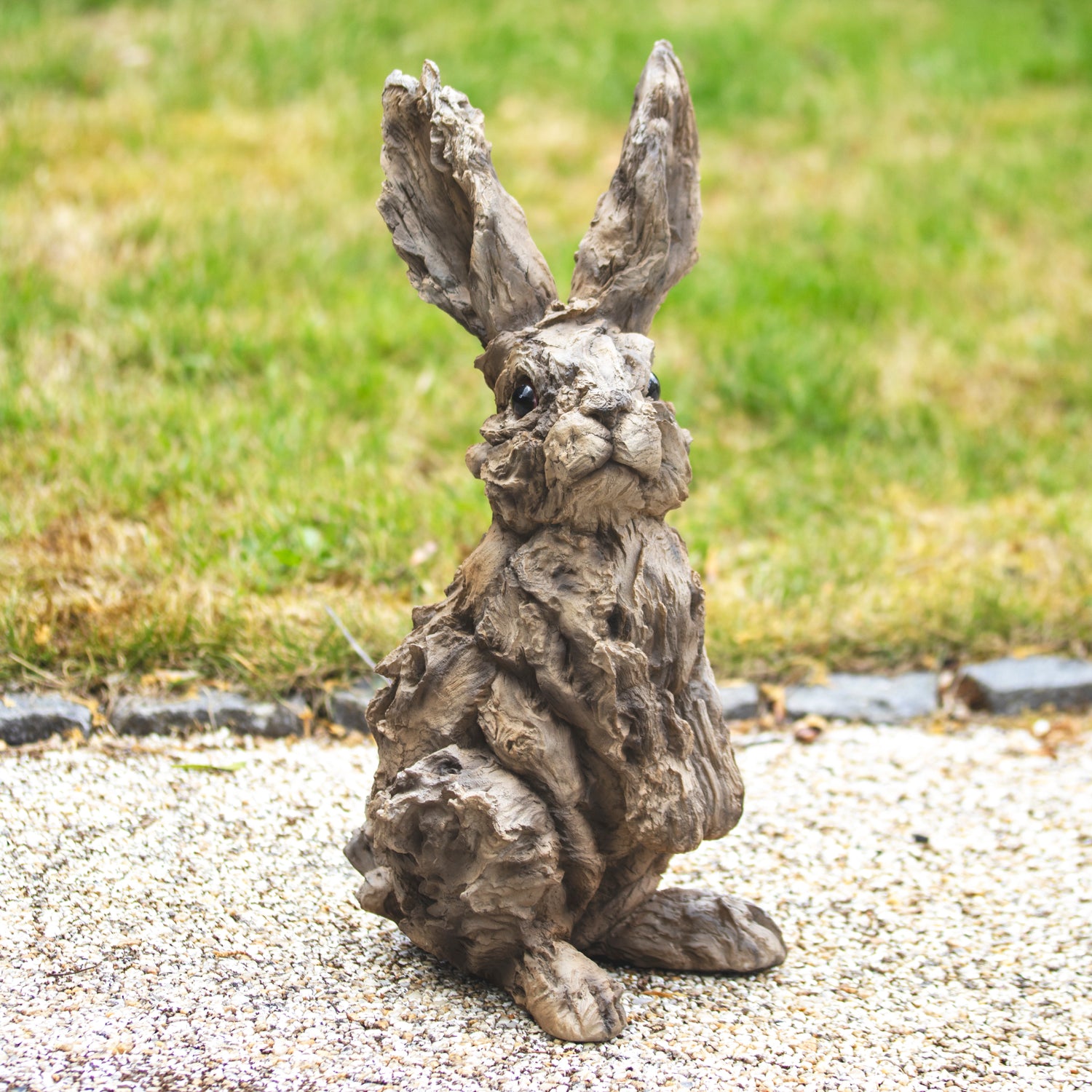 Rustic Wood Effect Hare Sculpture in a garden setting