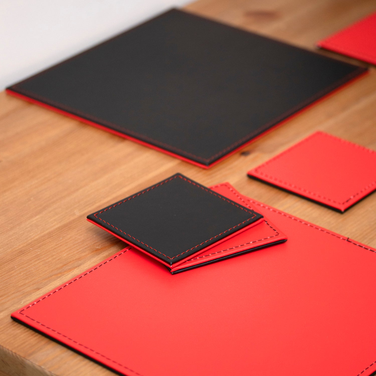Set of 4 Red/Black Reversible Faux Leather Placemats & Coasters