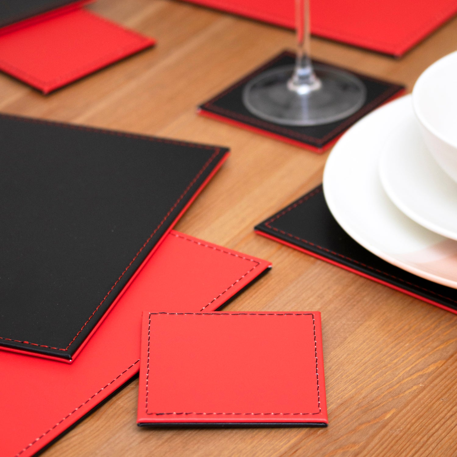 Set of 4 Red/Black Reversible Faux Leather Placemats & Coasters