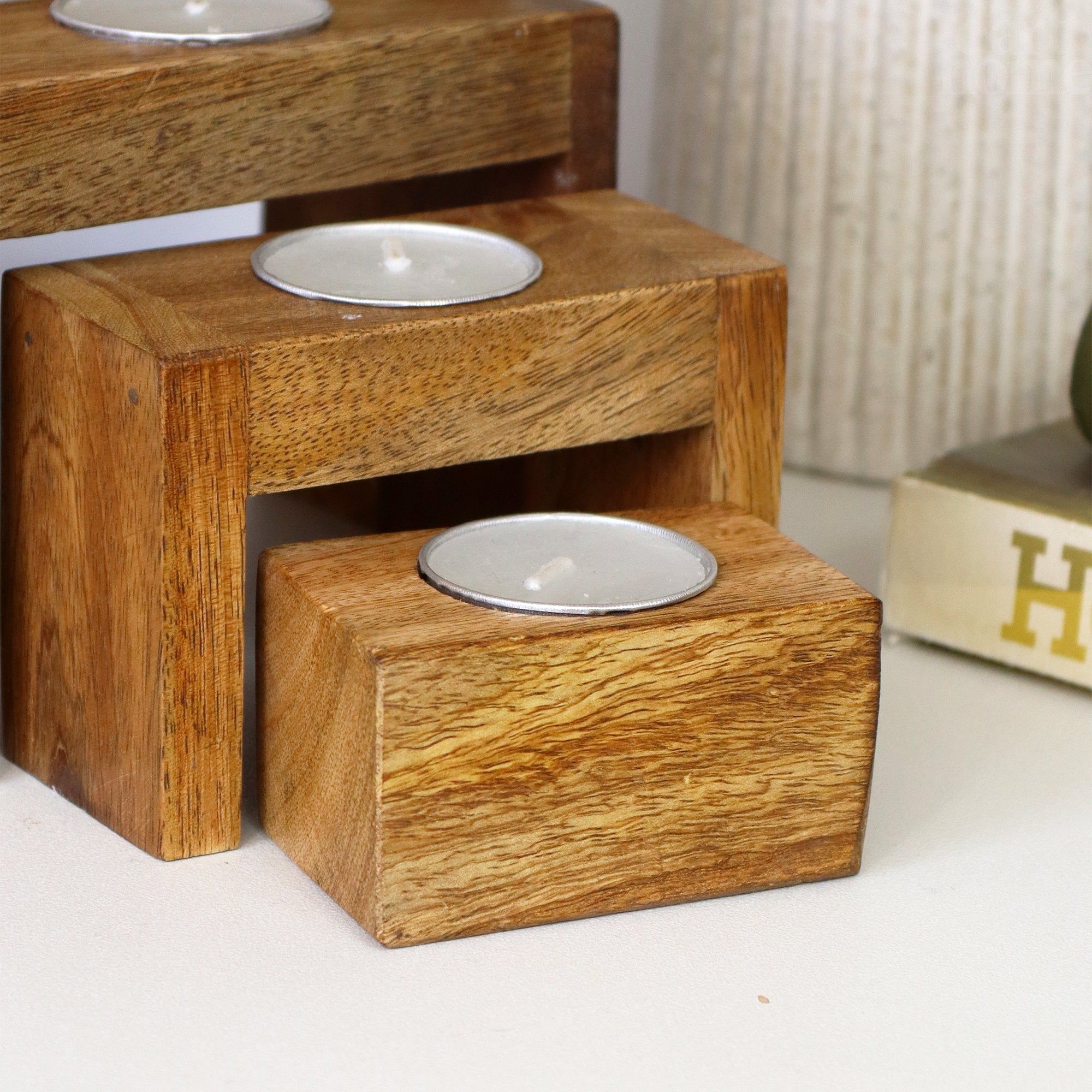 Set Of 4 Nesting Mango Wood Tea Light Holders With Candles