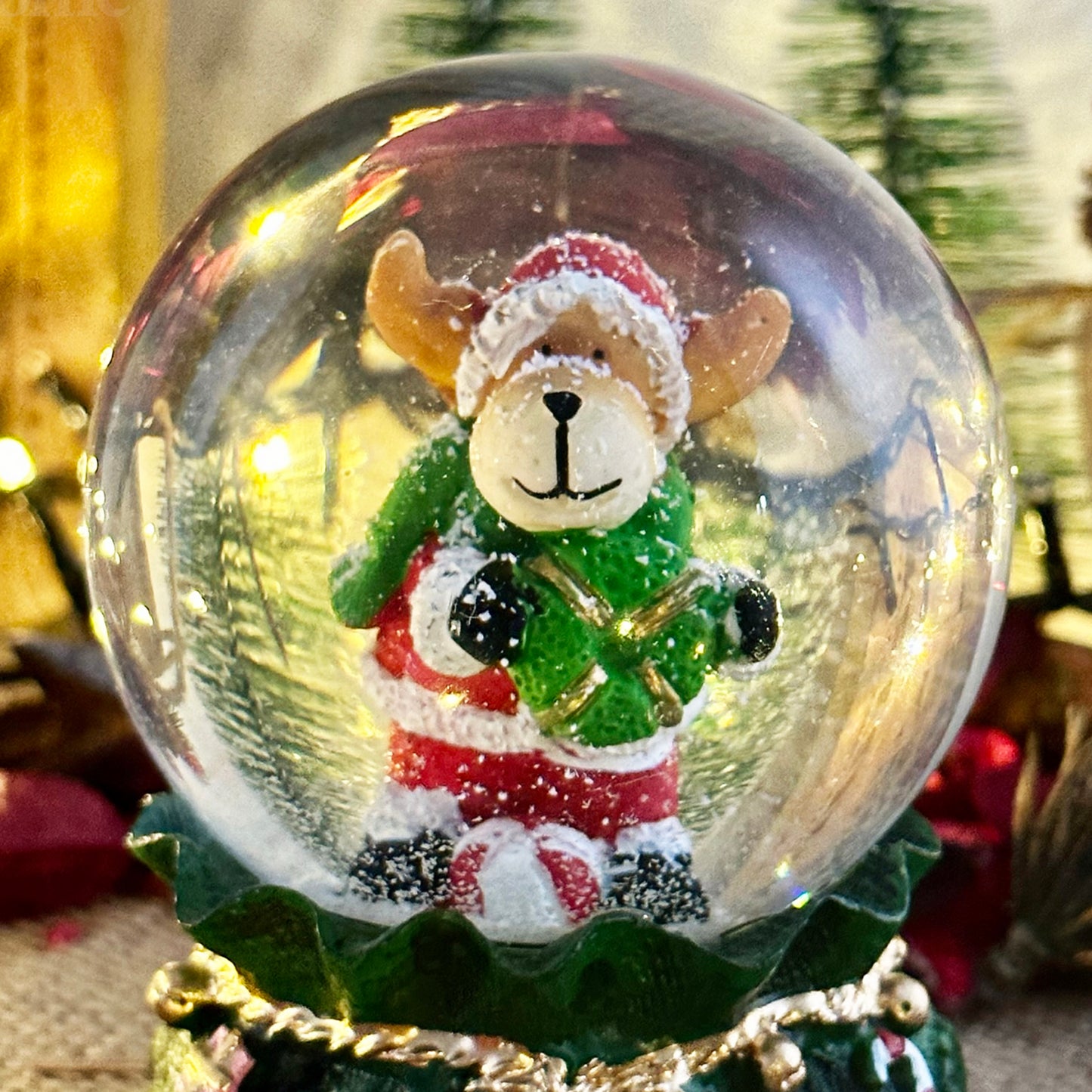 Reindeer In Green Sack Snow Globe