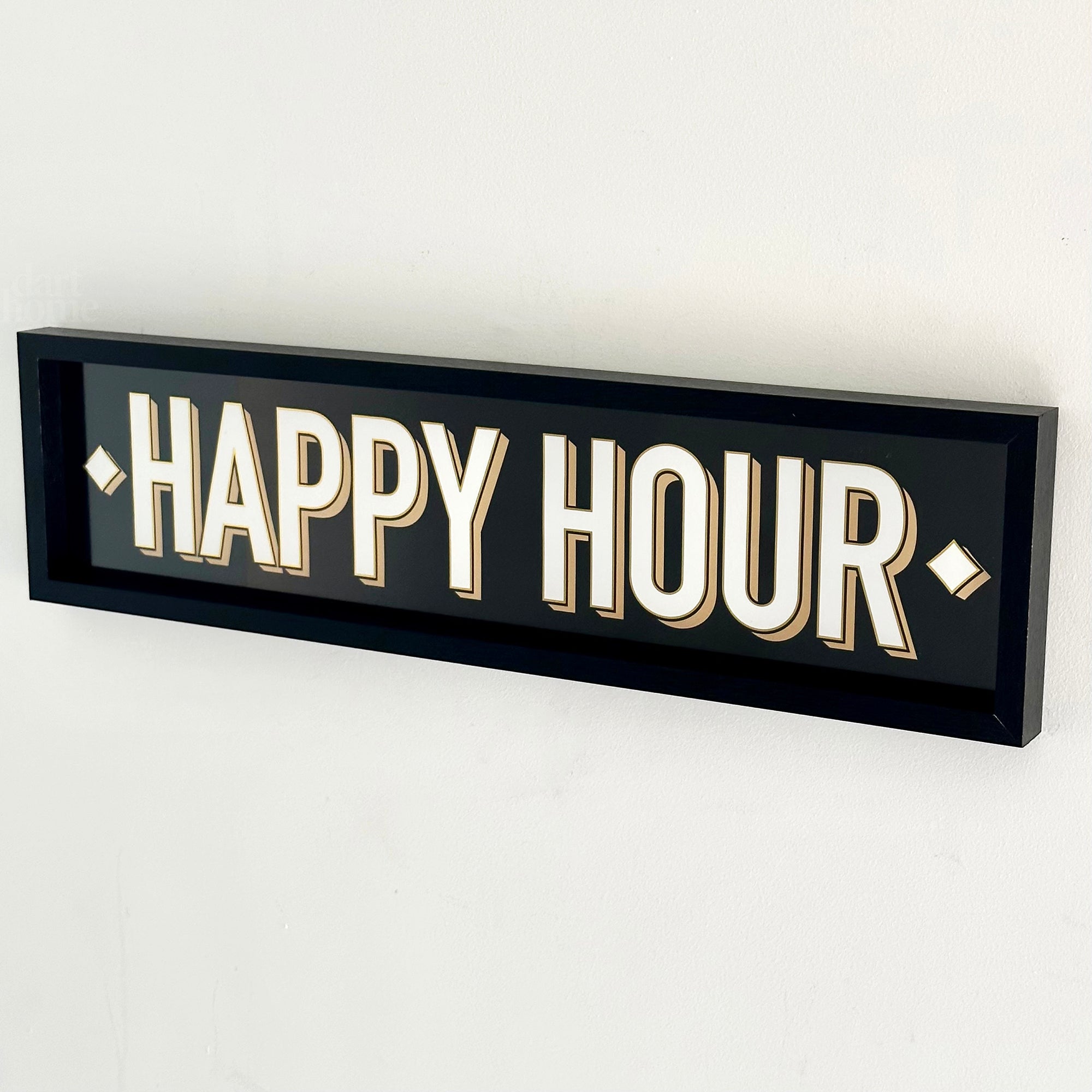 A black wood framed wall mounted 'Happy Hour' sign with block typography and a 3D effect.