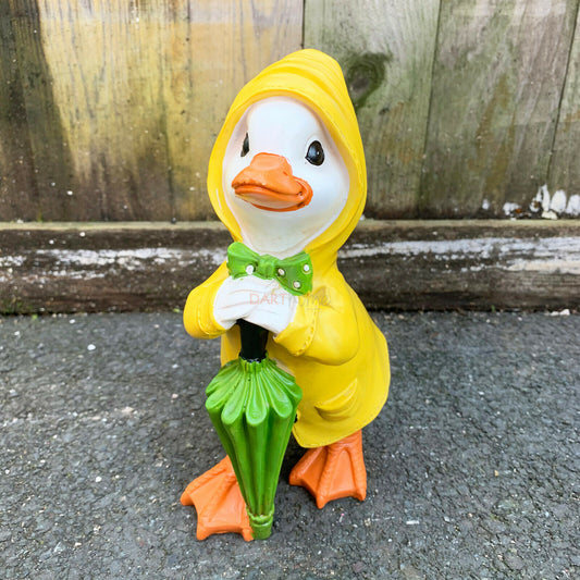 Stehende wintergelbe Entenfigur aus Kunstharz mit lehnendem Regenschirm, 20 cm