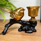Kerzenhalter mit goldenem Rotkehlchen auf schwarzem Zweig