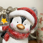 Leuchtende Pinguinfigur mit Geschenk