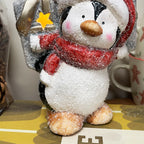 Leuchtende Pinguinfigur mit Geschenk