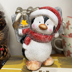 Leuchtende Pinguinfigur mit Geschenk