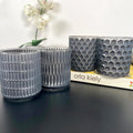 Set mit 4 geometrischen Teelichthaltern